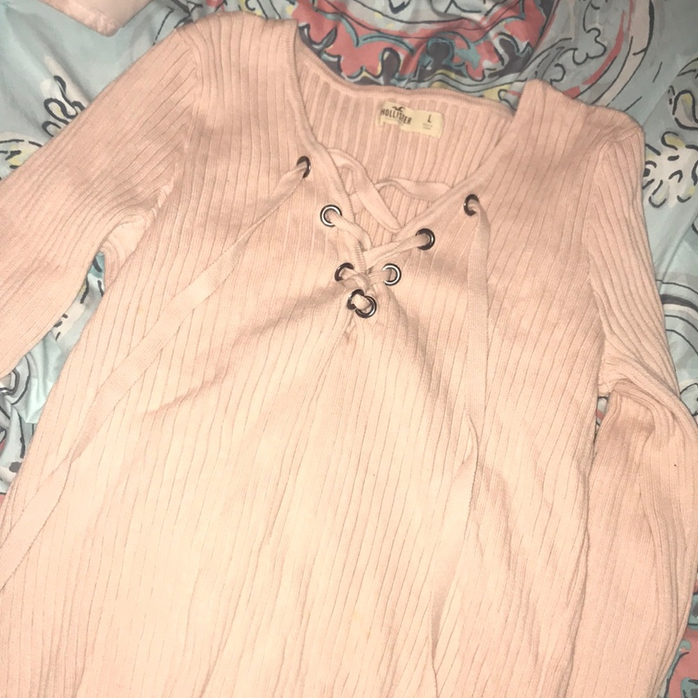 Pink Hollister sweater with crisscrossing detail
